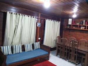 a living room with a couch and a table at Pousada Casa de Praia in Fernando de Noronha