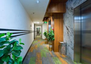 a hallway with plants in a building at Sunrise Central Hotel in Ho Chi Minh City