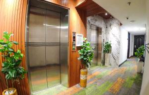 an elevator in a building with potted plants at Sunrise Central Hotel in Ho Chi Minh City