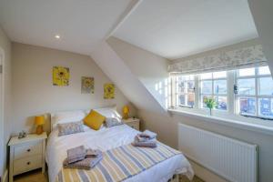 a bedroom with a bed and a window at Upper Thames & Lower Thames - Stunning apartments in Henley on Thames