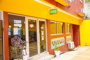 a yellow building with a sign on the front of it at Cypa Hotel in Abidjan