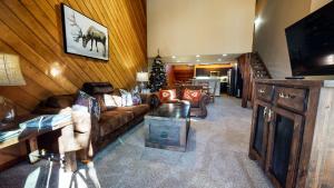 a living room with couches and a television and a christmas tree at Snowcreek Iii #415 Condo in Mammoth Lakes
