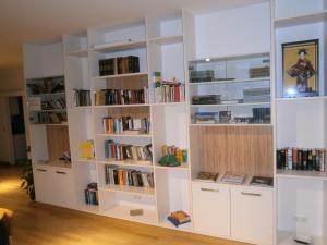 a room with white book shelves filled with books at Institut St.Sebastian in Salzburg