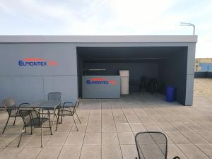a building with a table and chairs in front of it at Elmontex Air in Mošnov