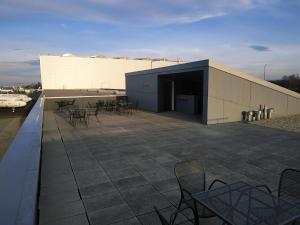 a building with chairs and tables on a patio at Elmontex Air in Mošnov
