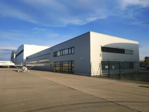 a small airplane parked in front of a building at Elmontex Air in Mošnov