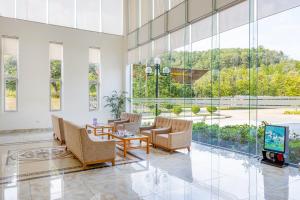 a lobby with chairs and a tv in a building at Anh Phát Resort in Tĩnh Gia