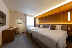Säng eller sängar i ett rum på The OneFive Terrace Fukuoka