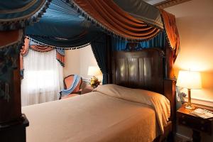 A bed or beds in a room at Monmouth Historic Inn