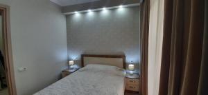Un dormitorio con una cama con dos luces. en The Apartment for Comfortable Vacations in Tbilisi., en Tiflis