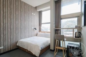 Postel nebo postele na pokoji v ubytování CJ Hotel