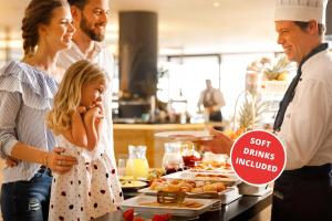 a family standing in a kitchen preparing food at Valamar Padova Hotel in Rab