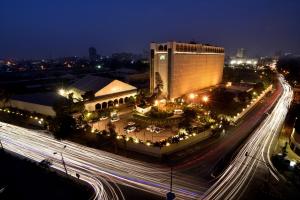 Una vista nocturna de un edificio y una carretera con luces. en Pearl Continental Hotel, Karachi, en Karachi