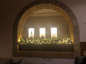 an archway with christmas lights in a room at Hotel dei Messapi in Muro Leccese