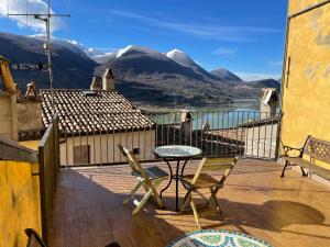 a balcony with a table and chairs and mountains at Ostello-Albergo dagli Elfi in Barrea