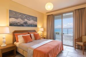 a bedroom with a bed with a view of the ocean at Villa White Stone by Rodostamo Collection in Kassiopi +28 photos