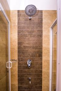 a shower with a shower head in a bathroom at Mapakada Village - Mahiyanganaya in Mahiyangana