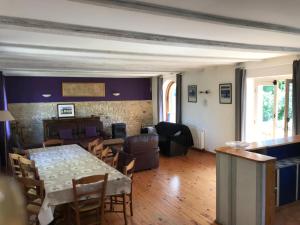 a dining room and living room with a table and chairs at Cidrerie, Coeur De Combray in Ernes