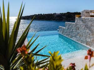 a swimming pool with a view of the water at Villa Kamen Blue in Vela Luka