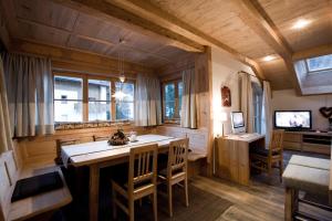 a kitchen with a table and chairs in a room at Chalet Corvara in Corvara in Badia