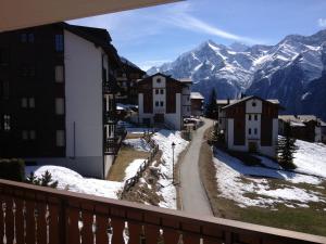 a view from a balcony of a town in the mountains at Appartement in 1700m mit Traumblick in Grächen