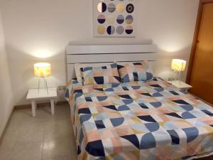 a bedroom with a bed and two lamps on tables at Casa Vacanze Filippa in Balestrate