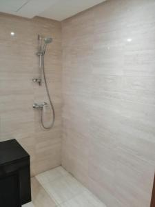 a bathroom with a shower with a shower head at Prestigia Marrakech Village Appartment in Marrakesh