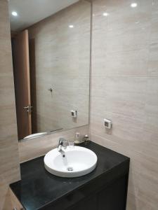 a bathroom with a sink and a mirror at Prestigia Marrakech Village Appartment in Marrakesh