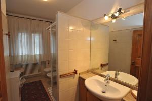 a bathroom with a sink and a toilet and a mirror at Baita Diana in Bormio +18 photos