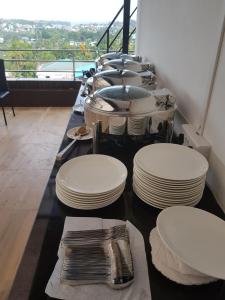 a long table with white plates on it at Hotel Seagull in Aberdeen