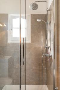 a shower with a glass door in a bathroom at Villa Leondari by Rodostamo Collection in Ágios Stéfanos