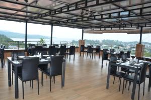 ein Restaurant mit schwarzen Tischen und Stühlen und Aussicht in der Unterkunft Hotel Seagull in Aberdeen