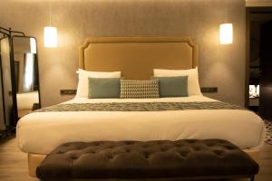 a bedroom with a large bed with a large headboard at Hotel Indigo Madrid - Gran Vía by IHG in Madrid