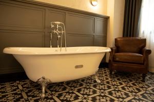 a white bath tub sitting in the middle of a room at Hotel Indigo Madrid - Gran Via, an IHG Hotel in Madrid