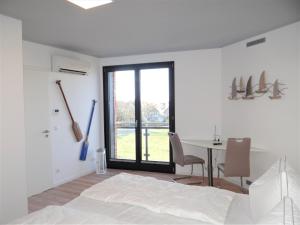 a bedroom with a bed and a table with chairs at Speicher Residenz Barth E3 App 7 in Barth