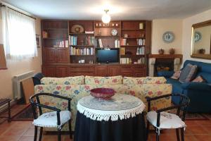 uma sala de estar com um sofá, uma mesa e cadeiras em Finca la barrosa ciudad y campo juntos em Zamora