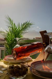 a glass bottle sitting on a table with plates and dishes at Agave Paradise in Puerto de la Cruz