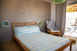 a bedroom with a bed and a chair and a window at Agave Paradise in Puerto de la Cruz +15 photos