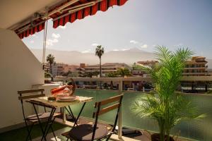 a patio with a table and chairs on a balcony at Agave Paradise in Puerto de la Cruz