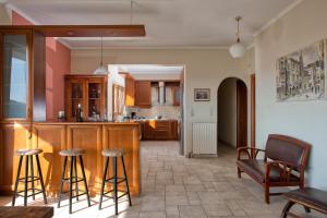 a kitchen with a bar and stools in a room at Mansion on the Hill by CorfuEscapes in Virós