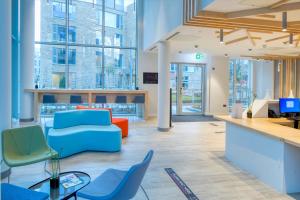 a lobby with a blue couch and chairs at The Westwood Summer Accommodation in Galway