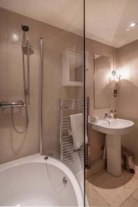 a bathroom with a shower and a tub and a sink at No 1 The Paragon in Bath