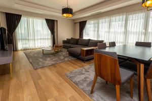 a living room with a table and a couch at Maslak Aparts in Istanbul