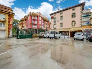 a parking lot in a city with cars parked at Hostal Restaurante La pinta in Ampuero