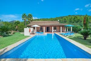 a swimming pool in front of a villa at Owl Booking Villa Romeu - 10 Min Walk to the Old Town in Pollença