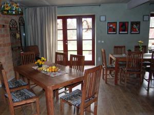 a dining room with a wooden table and chairs at Herberge Agape in Behlitz