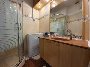 a bathroom with a sink and a toilet and a mirror at Sea View Deluxe in Bat Yam