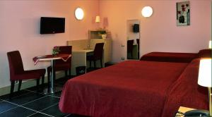 a hotel room with a bed and a table with chairs at Tus'Hotel in Castel di Tusa