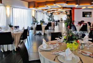 a restaurant with tables and chairs in a room at Tus'Hotel in Castel di Tusa