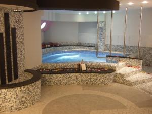 a large swimming pool in a hotel room at Tus'Hotel in Castel di Tusa